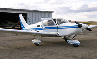 single engine private plane outside of hangar