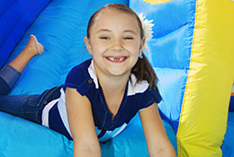 kid on inflatable slide