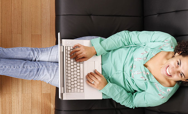 women using laptop on couch