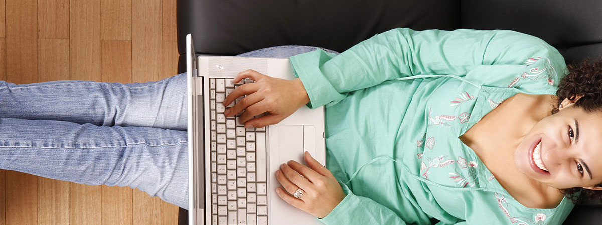 women-using-laptop-on-couch